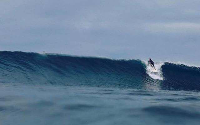 Surfer riding the Majestic wave at Puraran